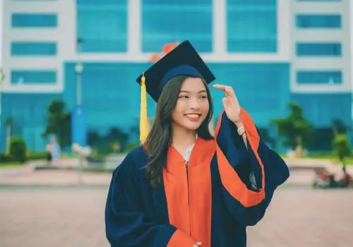 A confident graduate in a cap and gown, symbolizing IGEMA’s dedication to academic excellence and success.