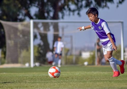 IGEMA young soccer player training on the field, showcasing sports talent development programs.